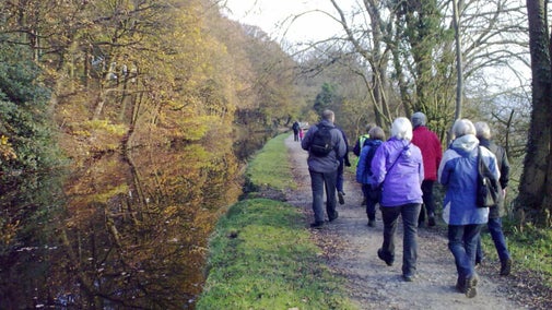 Group of walkers taking a stroll along the canal footpath